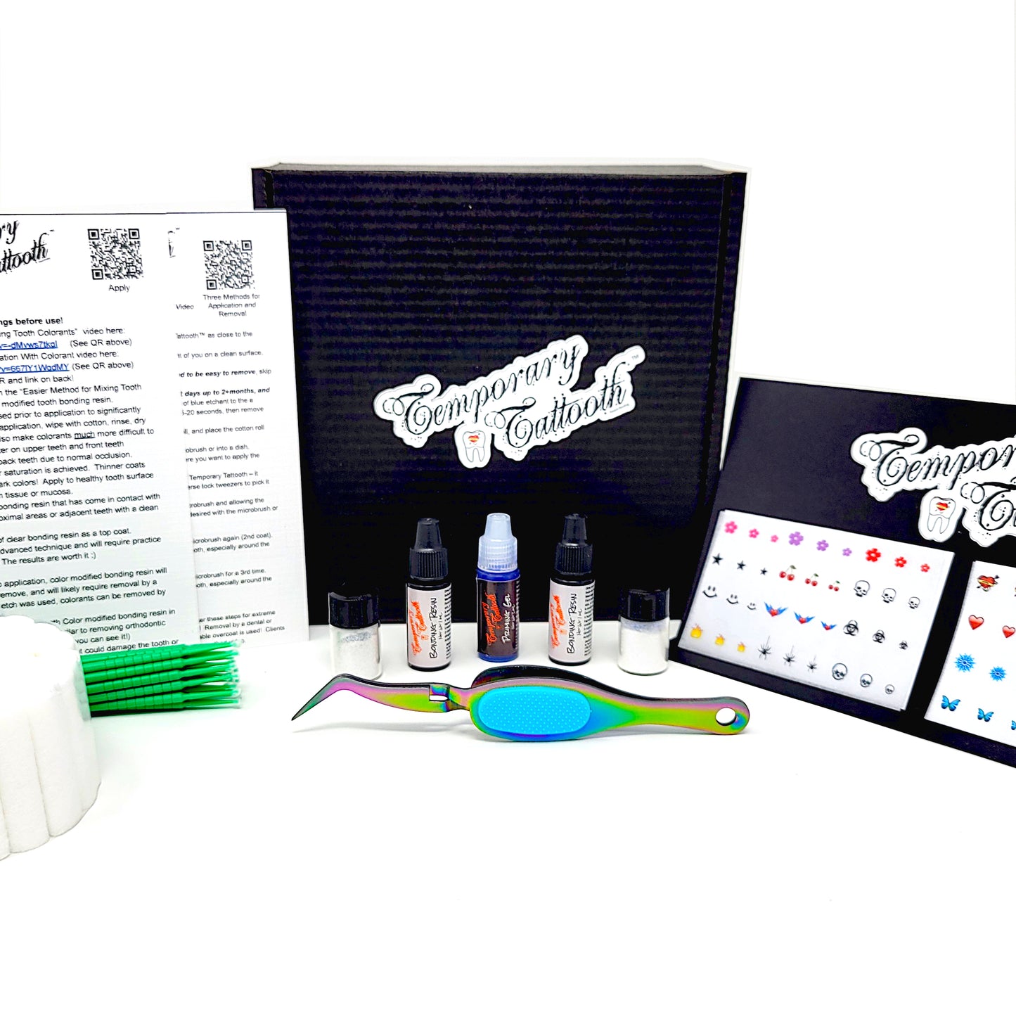 This is an image of the full Temporary Tattooth Essentials Kit that shows the tattooths, also known as tooth tattoos, as well as the tooth colorants. These products can be used to apply temporary tooth tattoos and colorants to teeth. The photo also shows reverse lock forceps and instructions to apply tooth tattoos and colorants.