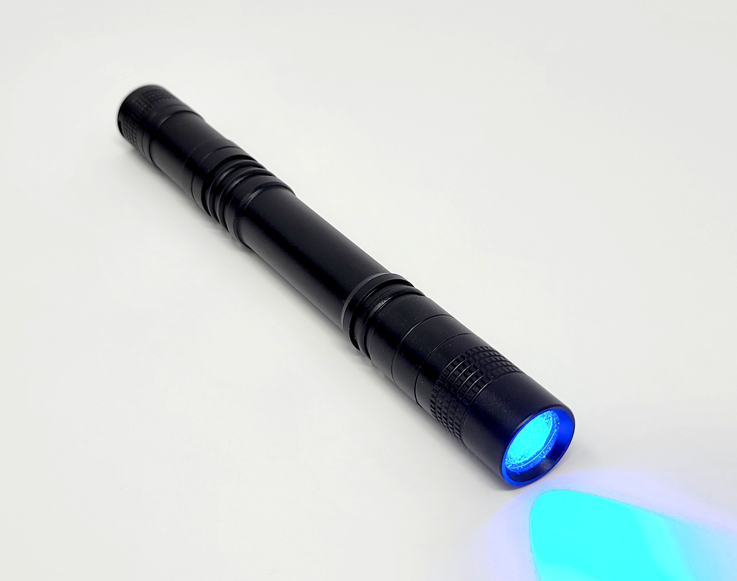 A photograph of a single Temporary Tattooth Ultralight that is on. This light can cure Temporary Tattooth Bonding resin required to apply temporary tattoos for teeth.