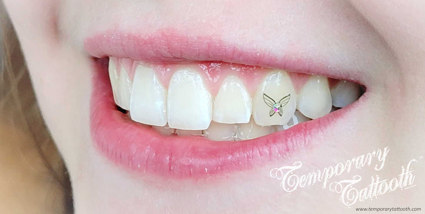 This is an image of a Temporary Tattooth.  It is a butterfly tooth tattoo with a small tooth gem attached to it's center.